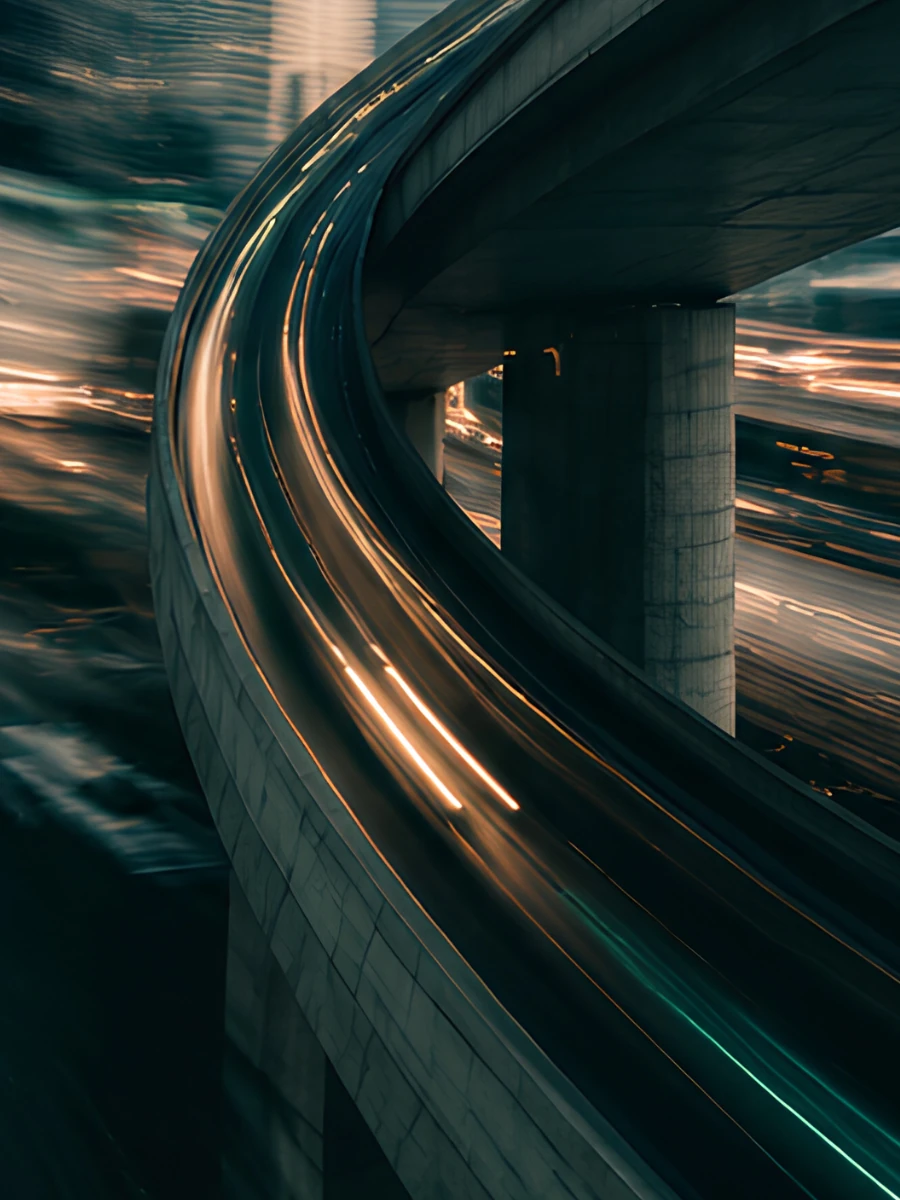 Mint and golden light trails follow a sweeping elevated road through the city.